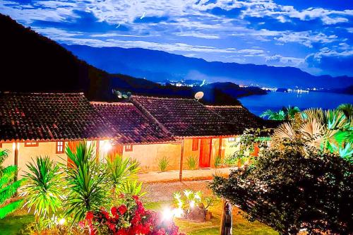 a house with a view of the water and mountains at Pousada Sonho Real in Angra dos Reis