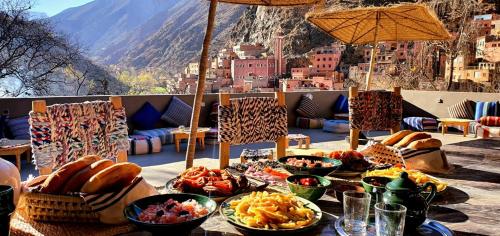 a table with bowls of food on top of a balcony at DAR JAMILA in Setti Fatma