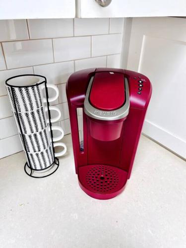 a red toaster sitting on a counter in a kitchen at Beautiful Farmhouse w/ pool on 6 acres ranch in Aubrey