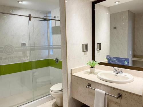 a bathroom with a toilet and a sink and a shower at Hotel Bogotá Regency Usaquén in Bogotá