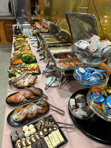 a buffet with many different types of food on a table at Hotel Vidović in Banja Luka