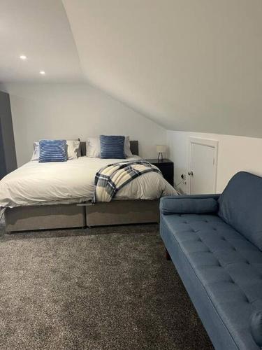 a bedroom with a bed and a couch at Albert House in Airdrie