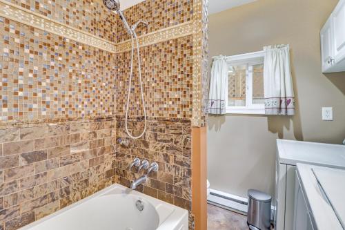 a bathroom with a shower and a bath tub at Riverfront Kresgeville Getaway Near Blue Mountain! 