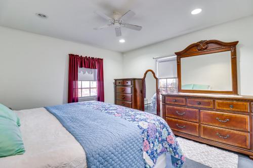 a bedroom with a bed and a dresser and a mirror at Riverfront Kresgeville Getaway Near Blue Mountain! 