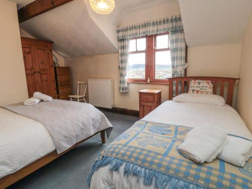 a bedroom with two beds and a window at Dale View in Whitby