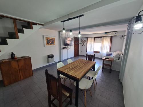 a dining room and living room with a table and chairs at Duplex 300 m del mar Barapoint in Necochea