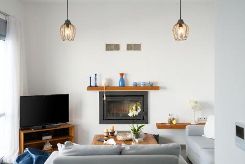 a living room with a couch and a tv at Ioannis House in Sellía