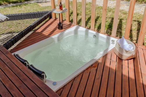 a hot tub sitting on a wooden deck at Shabbat Hotel Boutique in San Vicente