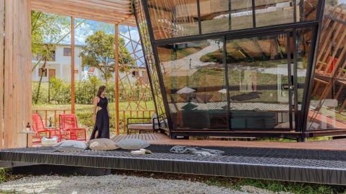 a woman walking in front of a building at Shabbat Hotel Boutique in San Vicente