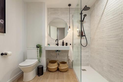 巴塞隆納的住宿－Elegant 4 Bedroom by Plaza Catalunya，一间带卫生间、水槽和镜子的浴室