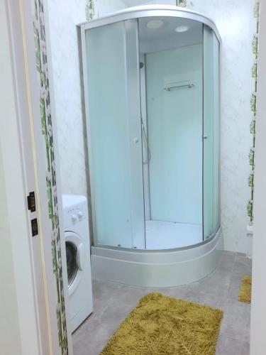 pralka w łazience ze szklanymi drzwiami w obiekcie Жк JanaAlem 57 w mieście Kokczetaw