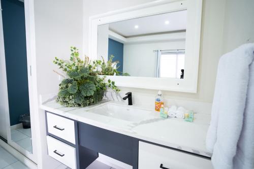 a bathroom with a white sink and a mirror at Hotel Mar Azul 