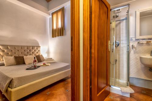 a bedroom with a bed and a shower and a sink at Sa Domo Apartments in Alghero