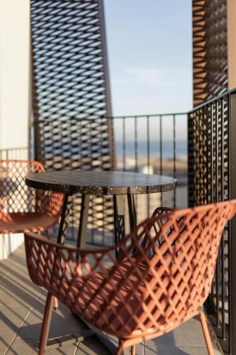 a black table and chairs on a balcony at Tembo Barcelona in Barcelona