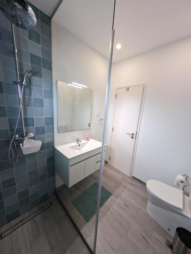 a bathroom with a sink and a toilet and a mirror at Casa Oliveira in Sagres