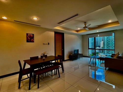 a living room with a dining table and a ceiling fan at Casa Residency in Kuala Lumpur