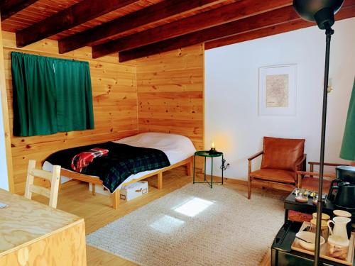 a bedroom with a bed in a wooden cabin at The Lorca Adirondacks Motel in Indian Lake