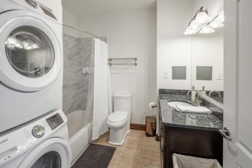 a bathroom with a washing machine and a washer at Sosuite at Independence Lofts - Callowhill in Philadelphia