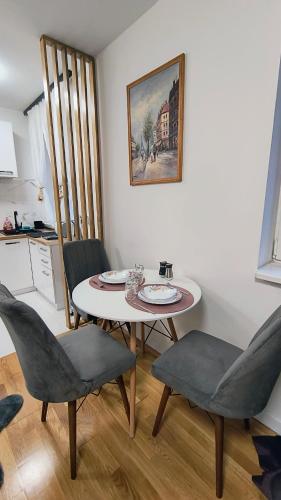 a dining room with a table and chairs in a kitchen at TALIJA in Vračar (historical)