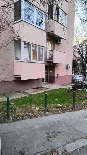 a pink apartment building with a parking lot at TALIJA in Vračar (historical)