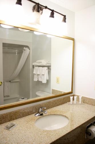 a bathroom with a sink and a large mirror at Country Inn & Suites by Radisson, BWI Airport Baltimore , MD in Linthicum Heights