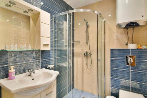 a bathroom with a sink and a shower at Central Area Retreat AC & WiFi in Varna City