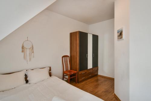 a bedroom with a bed and a chair at Central Area Retreat AC & WiFi in Varna City