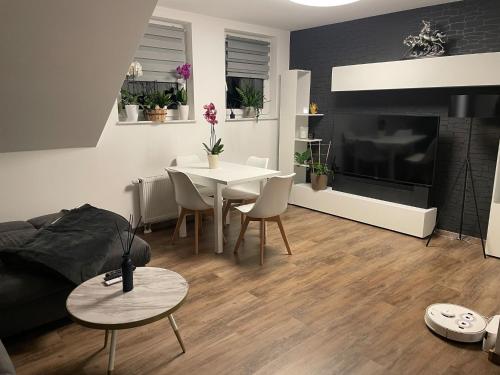 a living room with a table and a dining room at Ferienwohnung Rosa - b48939 in Horn-Bad Meinberg