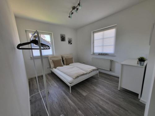 a small bedroom with a bed and a window at Ferienwohnung mit ruhiger Lage in Hilchenbach