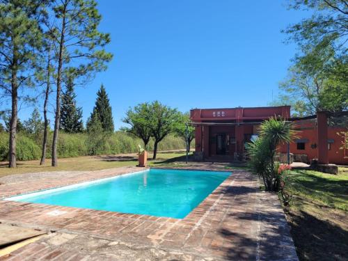 a swimming pool in front of a house at Casas de Campo in Santa María