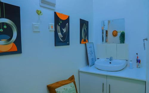 a blue bathroom with a sink and a mirror at Cade Homes 2 in Narok