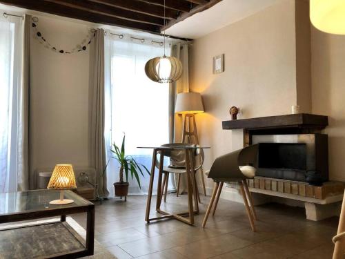 a living room with a fireplace and a table at Appartement au cœur de Paris /quartier Montorgueil in Paris