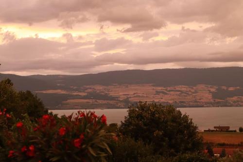 a view of a body of water with a cloudy sky at Chalet with Stunning Lake and Mountain Views avec une vue à couper le souffle, une spacieuse terrasse et jardin in Châtillon