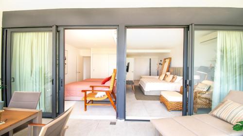 a room with sliding glass doors leading to a bedroom at Aria Ocean View Condo 206 by Kivoya in Nuevo Vallarta 