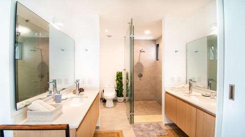 a bathroom with two sinks and a shower at Aria Ocean View Condo 206 by Kivoya in Nuevo Vallarta 