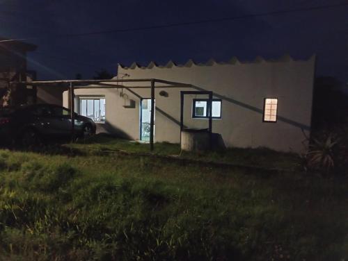 a small house at night with a car parked outside at Antoniopolis in Rocha