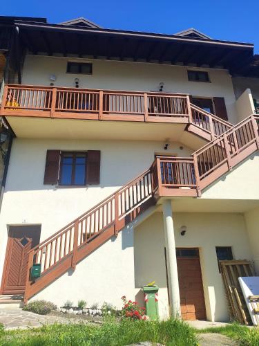 a house with a deck on the side of it at Casa Vacanze Lavanda & Rosmarino in Telve