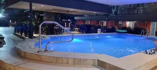 a large swimming pool in a hotel at night at V3 appartement in Paramaribo