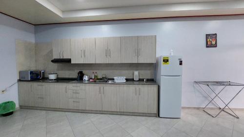 a kitchen with a white refrigerator in a room at V3 appartement in Paramaribo