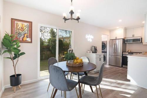 a kitchen and dining room with a table and chairs at Beautiful 3 Bed 1 Bath Designer Home + Hot Tub in North Hollywood