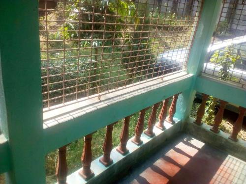 a balcony with a window with a fence at Sonarbangla in Digha