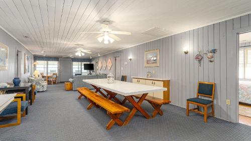 a living room with a table and chairs at Barnett House Top - Oceanfront - Windy Hill Section in Myrtle Beach
