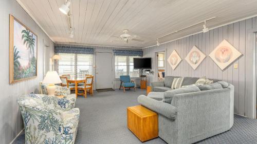 a living room with two couches and a dining room at Barnett House Top - Oceanfront - Windy Hill Section in Myrtle Beach