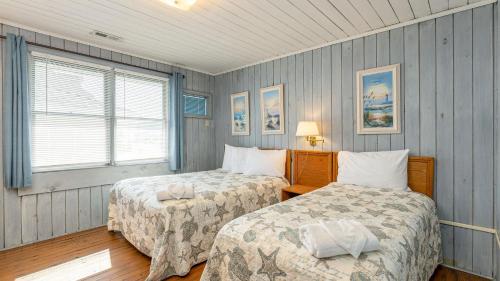a bedroom with two beds and a window at Barnett House Top - Oceanfront - Windy Hill Section in Myrtle Beach
