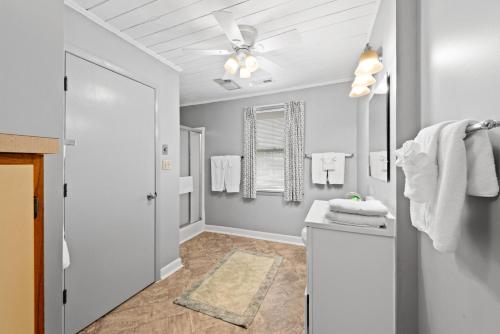 a bathroom with a ceiling fan and a sink at Barnett House Top - Oceanfront - Windy Hill Section in Myrtle Beach