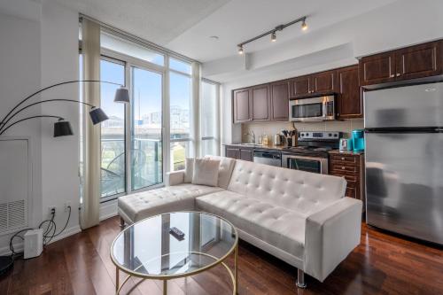 a living room with a couch and a glass table at DownTown Toronto luxury condo in Toronto