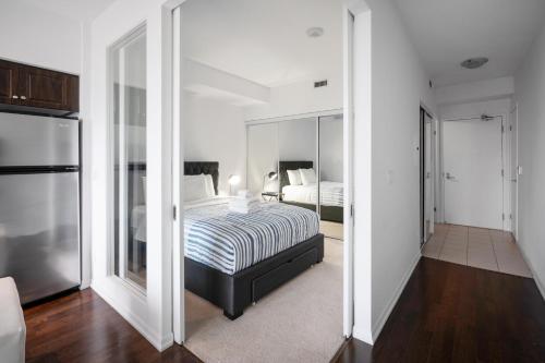 a bedroom with a bed and a large mirror at DownTown Toronto luxury condo in Toronto