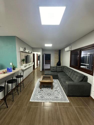 a living room with a couch and a table at Casa Liberdade in Novo Hamburgo