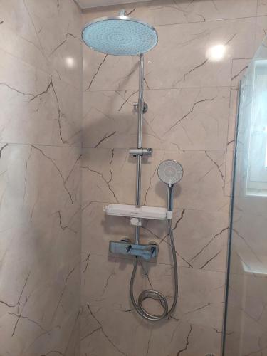 a shower with a shower head in a bathroom at Holiday apartment in Vodice