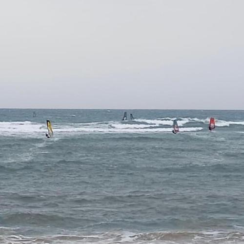 a group of people wind surfing in the ocean at Sarah Delight in Pýrgos